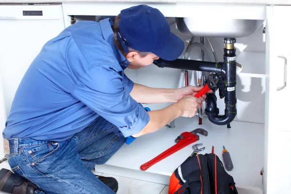 a male plumber fixing a toilet from Plumber Georgetown in Georgetown, TX  